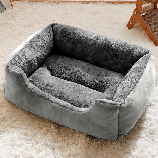 Plush square bolster bed in grey with a dog resting in it