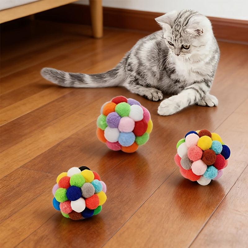 Cat batting a bell ball across the floor